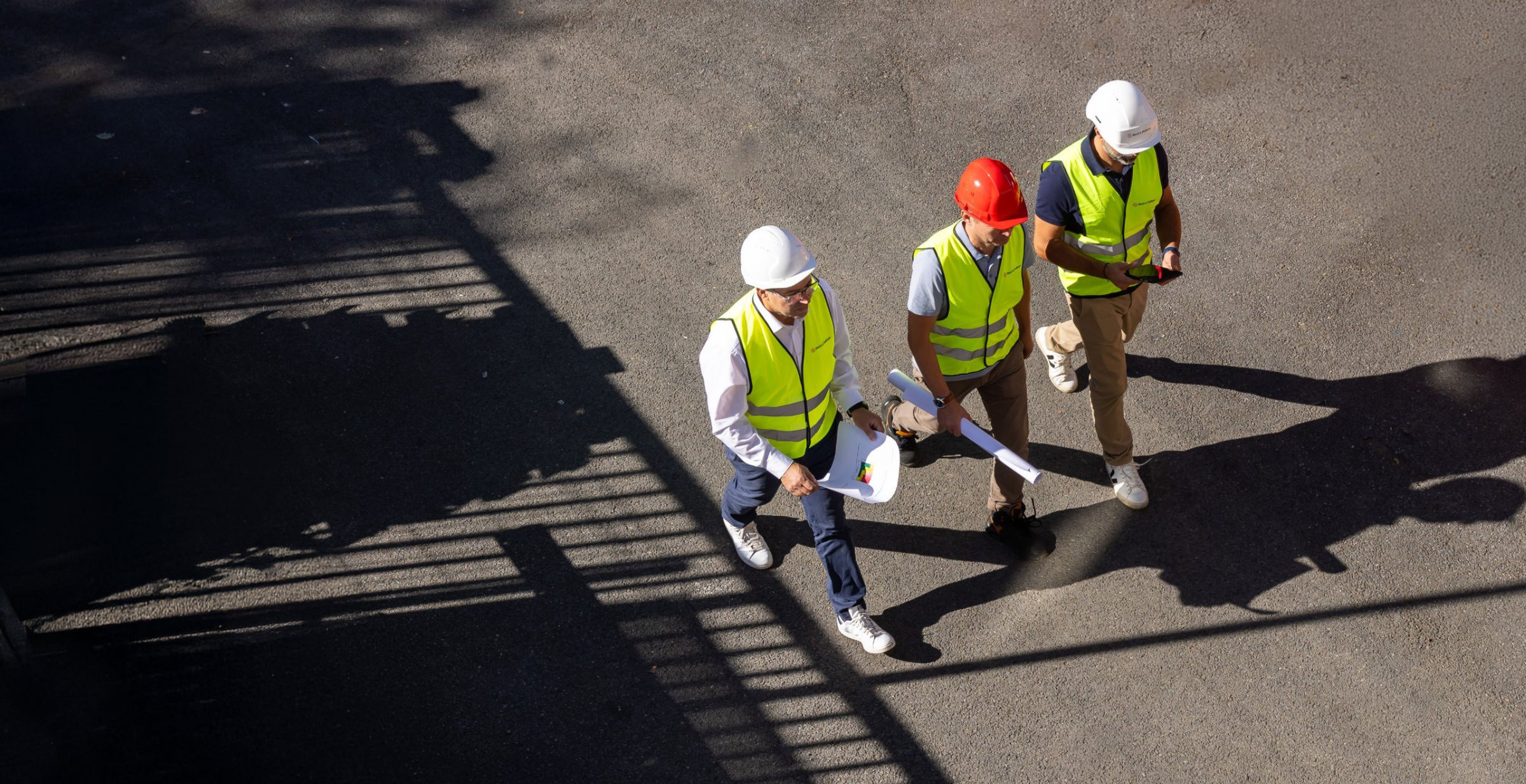 Industrial consulting team planning a manufacturing project on site